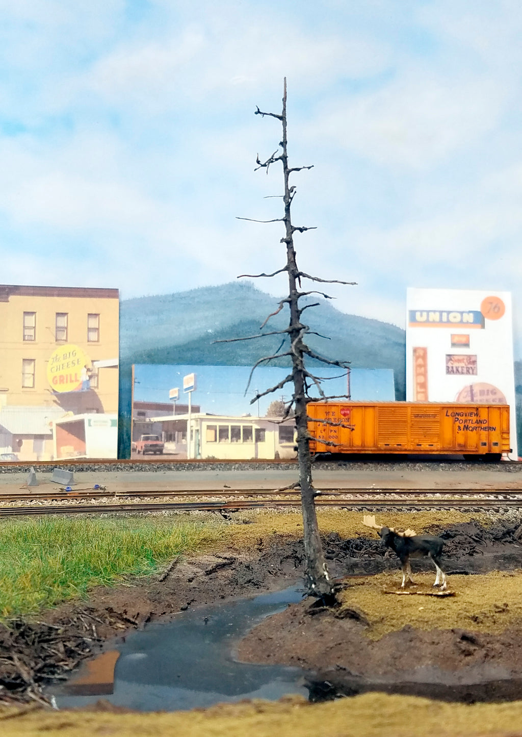 A 5 inch HO scale model railroad dead snag ghost tree leaning over a creek on Roger's POTB HO scale model railroad layout for Coastman's Scenic Products.