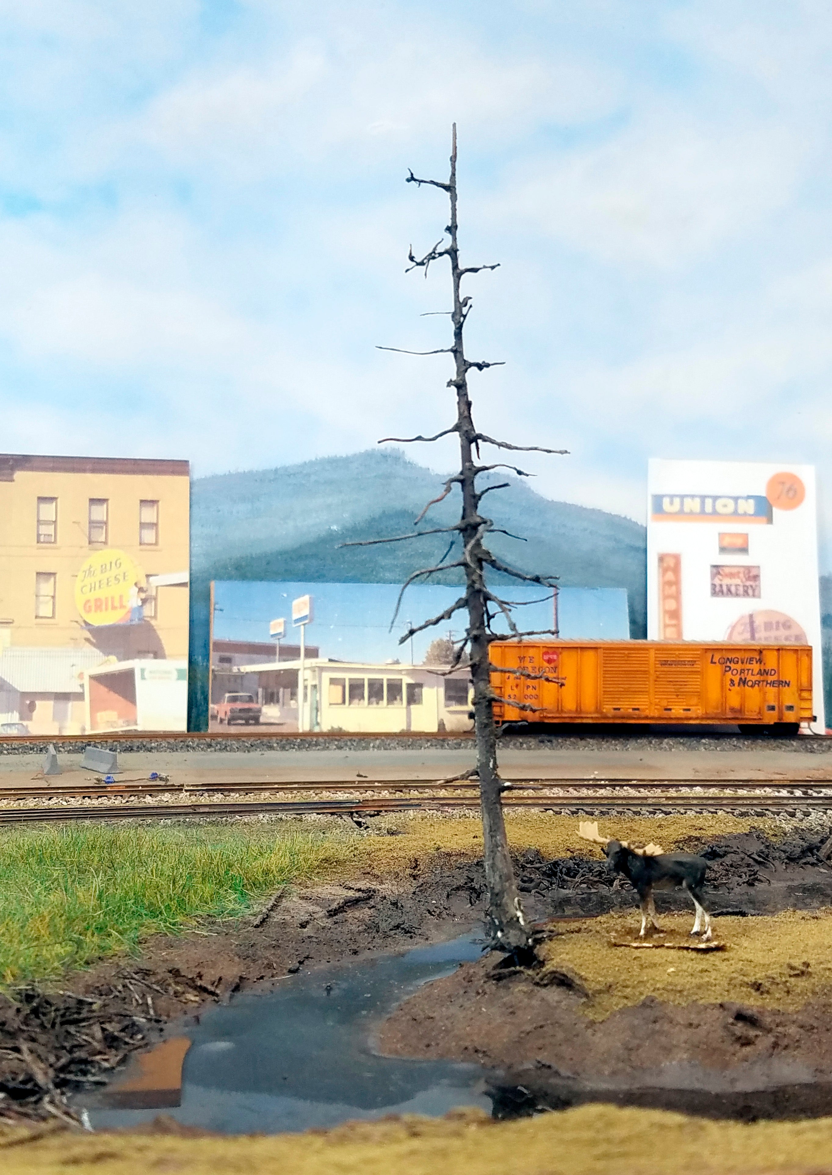 A 5 inch HO scale model railroad dead snag ghost tree leaning over a creek on Roger's POTB HO scale model railroad layout for Coastman's Scenic Products.