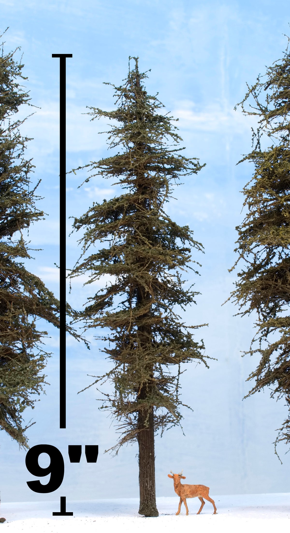 A Coastman's Standard 9 inch tall model fir tree with HO scale deer alongside and measurement unit value 9" text also showing foliage detail.