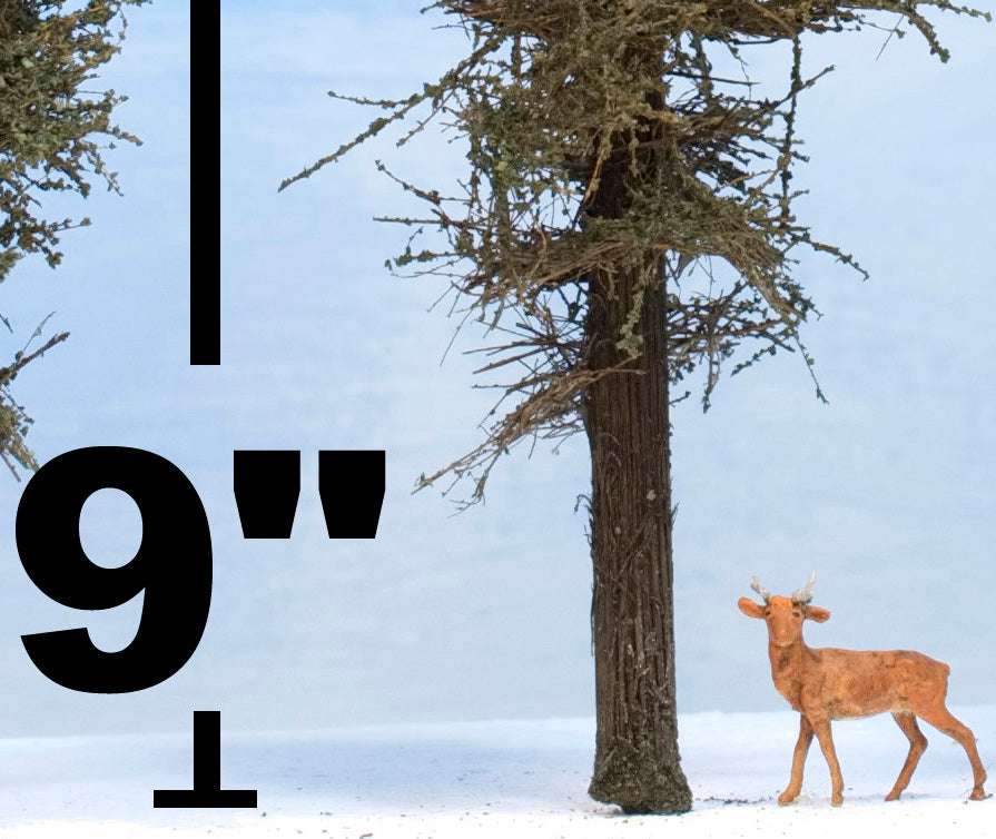 Close up of a Coastman's Standard 9 inch tall model fir tree with HO scale deer alongside and measurement unit value 9" text also showing foliage detail.