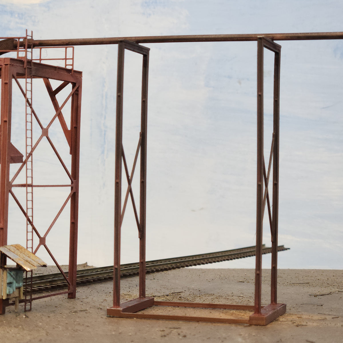 Detail of HO scale wood chip loader feeder supports structural assembly including feeder tube, and height adjustment jig modeled in HO scale by Roger Rasmussen of Coastman's Scenic Products.