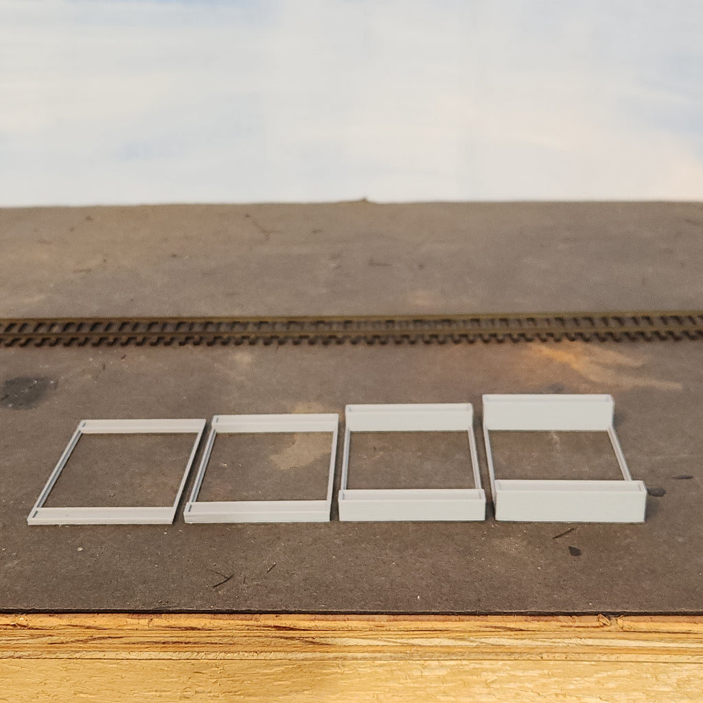 HO scale concrete riser pads for use with the feeder tube supports to provide elevation to the feeder tube on the HO scale Wood Chip Loader manufactured by Coastman's Scenic Products.