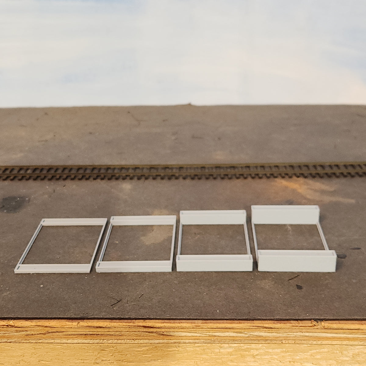 HO scale concrete riser pads for use with the feeder tube supports to provide elevation to the feeder tube on the HO scale Wood Chip Loader manufactured by Coastman's Scenic Products.