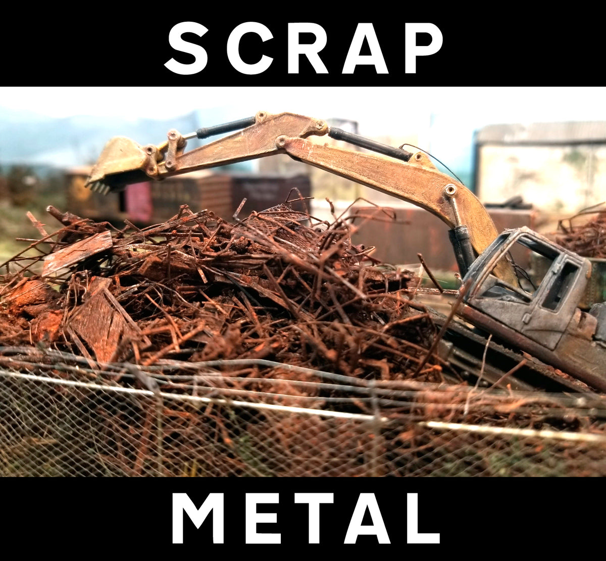 Citrus Recyclers at work on Roger's HO scale OCRX layout with a backhoe hovering over the shredded scrap metal which is actually made of PLA, with HO scale railroad track for scale reference. Photo by Roger Rasmussen, CSP LLC, 97465.