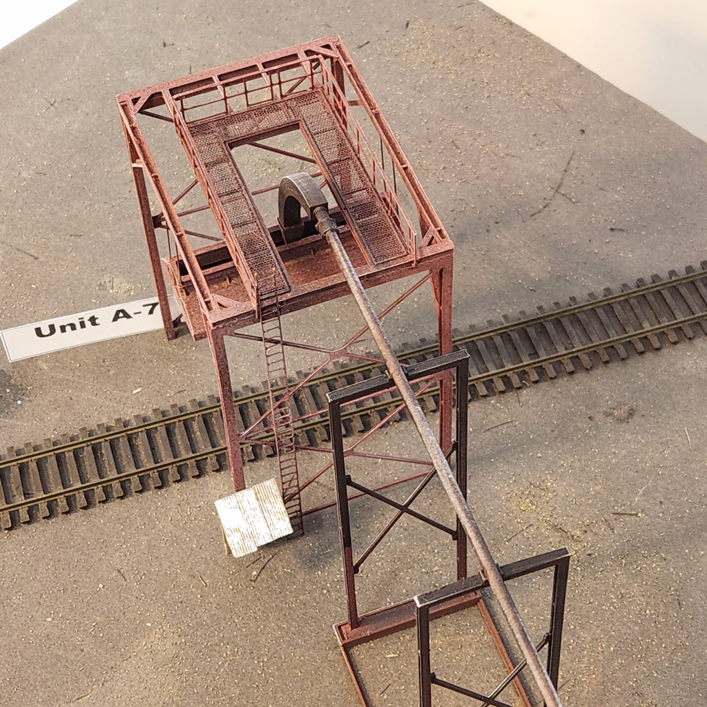 Overhead angled close up shot of the HO scale Unit A-7 Wood Chip Loader offered by Coastman's showing safety rail, ladder, loading mechanism tubing, and grated walkway details.