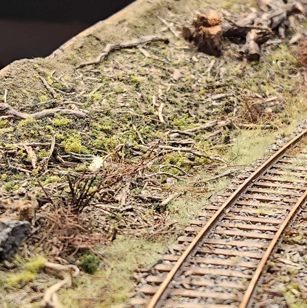 Roger's Port of Tillamook Bay HO scale model railroad layout featuring Coastman's 100% natural kiln dried Forest Floor material scattered near the railroad tracks. 